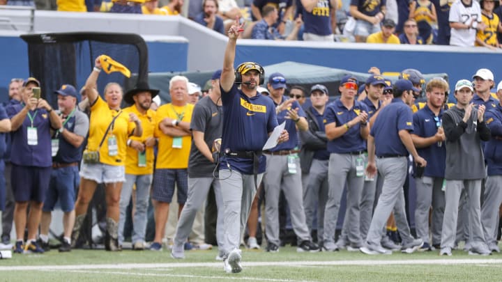 Aug 31, 2024; Morgantown, West Virginia, USA; West Virginia Mountaineers head coach Neal Brown calls for a two-point conversion after a touchdown during the fourth quarter against the Penn State Nittany Lions at Mountaineer Field at Milan Puskar Stadium.