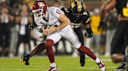 Nov 9, 2024; Columbia, Missouri, USA; Oklahoma Sooners quarterback Jackson Arnold (11) runs the ball against Missouri Tigers defensive end Eddie Kelly Jr. (97) during the first half at Faurot Field at Memorial Stadium. Mandatory Credit: Jay Biggerstaff-Imagn Images
