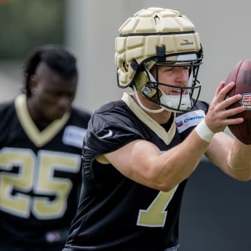 Jun 13, 2023; New Orleans, LA, USA;  New Orleans Saints tight end Taysom Hill (7) passes during minicamp at the Ochsner Sports Performance Center. Mandatory Credit: Stephen Lew-USA TODAY Sports
