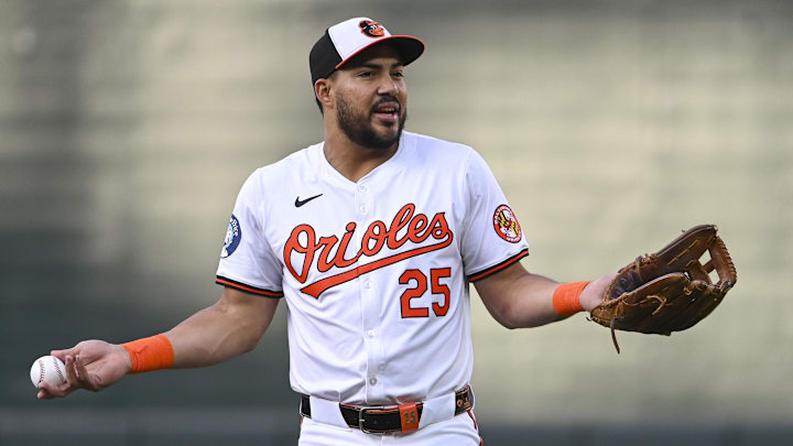 Sep 4, 2024; Baltimore, Maryland, USA;  Baltimore Orioles outfielder Anthony Santander (25) reacts while speaking with teammates iin the field before the game against the Chicago White Sox at Oriole Park at Camden Yards.