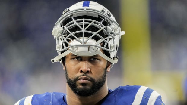 Indianapolis Colts defensive player DeForest Buckner waits to start the game while wearing a white helmet and blue jersey.
