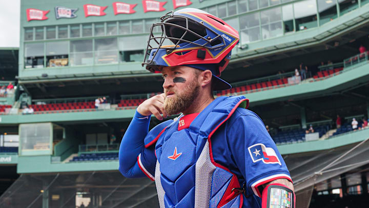 May 8, 2025; Boston, Massachusetts, USA; Texas Rangers catcher Tucker Barnhart (18) makes his way to the bullpen before the start of the game against the Boston Red Sox at Fenway Park May 8, 2025; Boston, Massachusetts, USA; Texas Rangers catcher Tucker Barnhart (18) makes his way to the bullpen before the start of the game against the Boston Red Sox at Fenway Park