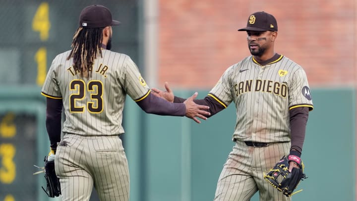 Apr 6, 2024; San Francisco, California, USA; San Diego Padres second baseman Xander Bogaerts (right) slaps hands with right fielder Fernando Tatis Jr. (23) during the first inning against the San Francisco Giants at Oracle Park. Mandatory Credit: Darren Yamashita-USA TODAY Sports