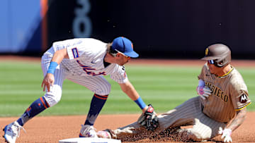 Sep 18, 2025; New York City, New York, USA; New York Mets second baseman Jeff McNeil (1) tags out San Diego Padres third baseman Manny Machado (13) at second base trying to stretch a single into a double during the first inning at Citi Field. Mandatory Credit: Brad Penner-Imagn Images