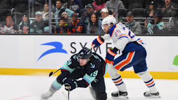 Seattle Kraken left wing Jared McCann (19) and Edmonton Oilers center Leon Draisaitl (29) play the puck