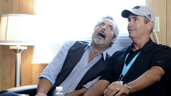 CBS Sports personality David Feherty jokingly makes a face next to colleague Ian Baker-Finch as they interview with other media at the CBS compound during a practice round for the 2015 PGA Championship golf tournament at Whistling Straits -The Straits Course on Aug. 12, 2015.