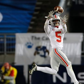 Ohio State Buckeyes quarterback Justin Fields throws a pass to wide receiver Garrett Wilson