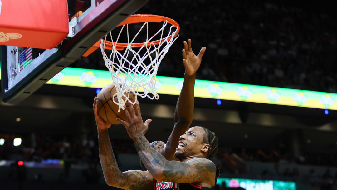 Apr 19, 2024; Miami, Florida, USA; Chicago Bulls forward DeMar DeRozan (11) drives to the basket against Miami Heat center Bam Adebayo (13) in the second quarter during a play-in game of the 2024 NBA playoffs at Kaseya Center. Mandatory Credit: Sam Navarro-USA TODAY Sports
