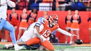 Oct 31, 2025; Syracuse, New York, USA; Syracuse Orange quarterback Joseph Filardi (13) loses a fumble on a tackle by North Carolina Tar Heels defensive lineman Melkart Abou Jaoude (9) in the fourth quarter at the JMA Wireless Dome. 