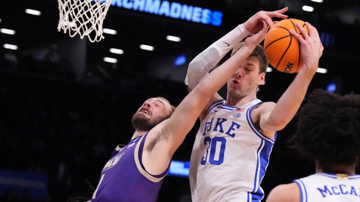 Mar 24, 2024; Brooklyn, NY, USA; Duke Blue Devils center Kyle Filipowski (30) gets a rebound over James Madison Dukes guard Noah Freidel (1) in the second round of the 2024 NCAA Tournament  at Barclays Center. Mandatory Credit: Robert Deutsch-USA TODAY Sports