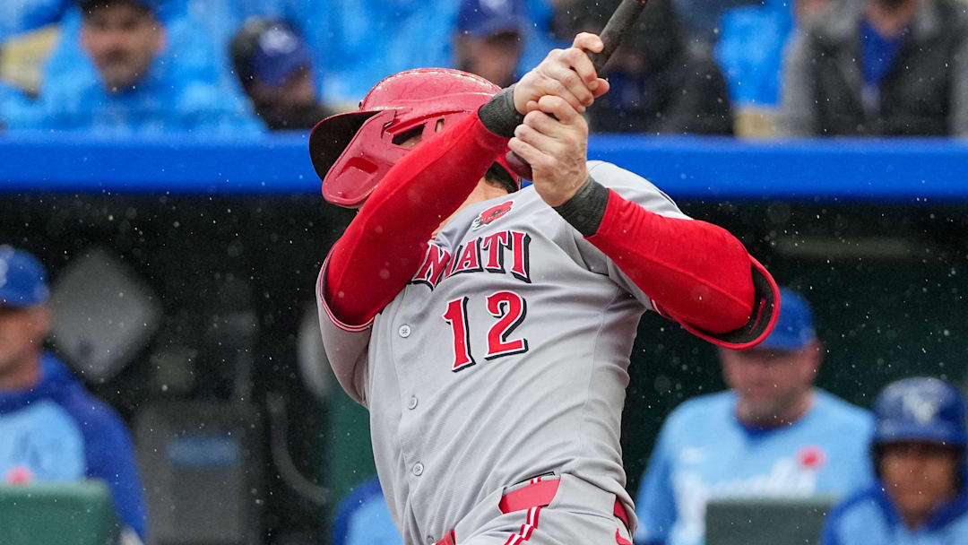 May 26, 2025; Kansas City, Missouri, USA; Cincinnati Reds left fielder Austin Hays (12) hits a one run sacrifice fly against the Kansas City Royals in the first inning at Kauffman Stadium. Mandatory Credit: Denny Medley-Imagn Images