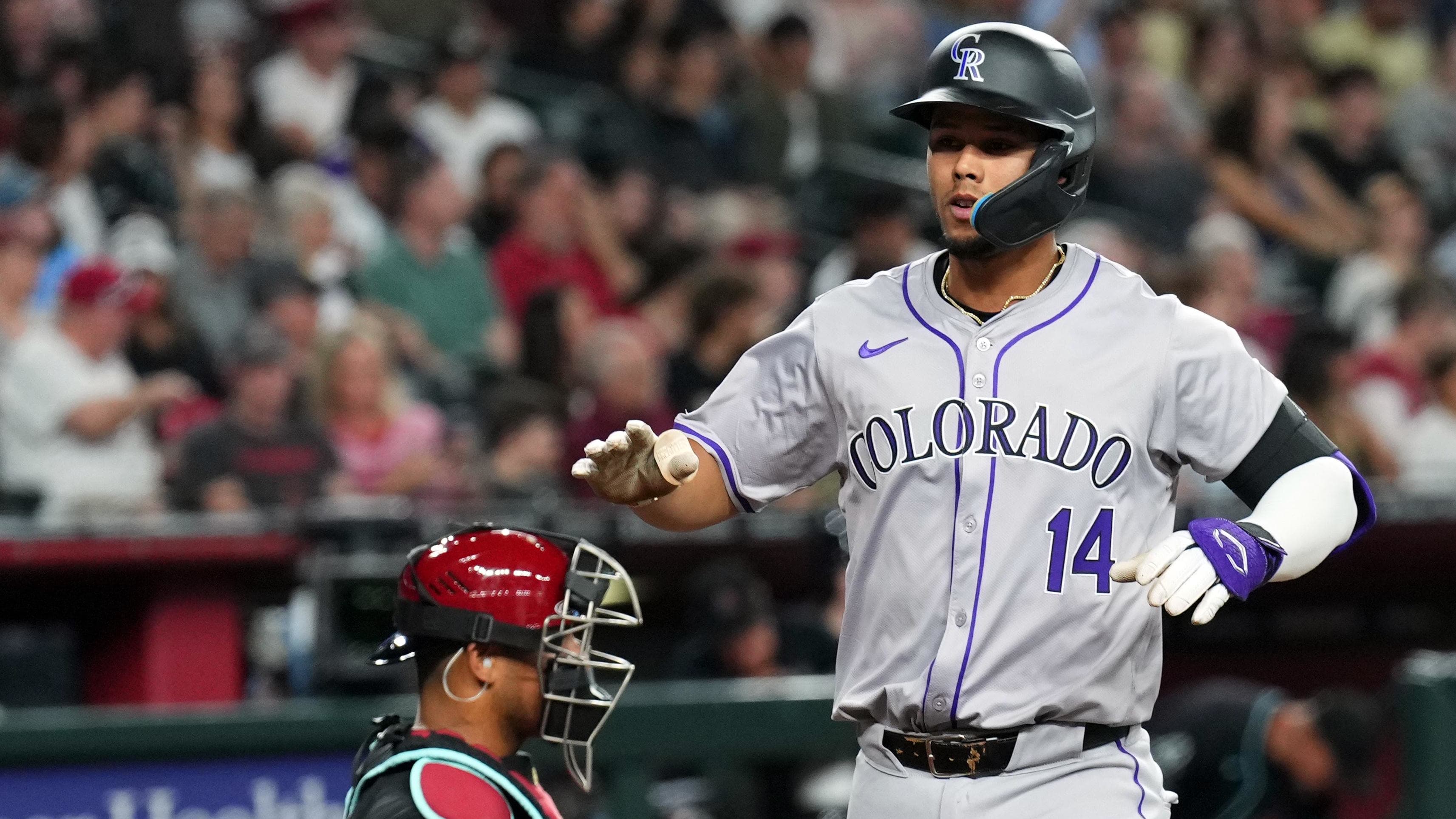Colorado Rockies shortstop Ezequiel Tovar (14) scores after hitting a two-run home run in the second inning.