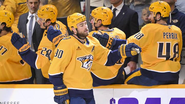 Oct 23, 2025; Nashville, Tennessee, USA;  Nashville Predators center Ryan O'Reilly (90) celebrates with his teammates after scoring a goal against the Vancouver Canucks during the second period at Bridgestone Arena. Mandatory Credit: Steve Roberts-Imagn Images