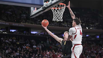 Dec 10, 2024; New York, New York, USA;  Michigan Wolverines center Danny Wolf (1) drives past Arkansas Razorbacks forward Trevon Brazile (4) in the second half at Madison Square Garden. Mandatory Credit: Wendell Cruz-Imagn Images