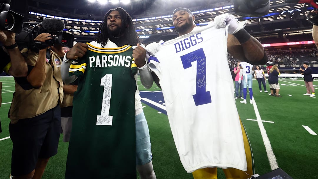 Sep 28, 2025; Arlington, Texas, USA; Green Bay Packers defensive end Micah Parsons (1) and Dallas Cowboys cornerback Trevon Diggs (7) exchange jerseys after the game at AT&T Stadium. Mandatory Credit: Kevin Jairaj-Imagn Images
