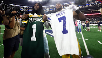 Sep 28, 2025; Arlington, Texas, USA; Green Bay Packers defensive end Micah Parsons (1) and Dallas Cowboys cornerback Trevon Diggs (7) exchange jerseys after the game at AT&T Stadium. Mandatory Credit: Kevin Jairaj-Imagn Images