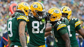Green Bay Packers wide receiver Romeo Doubs (87) celebrates scoring a touchdown with wide receiver Christian Watson (9), wide receiver Jayden Reed (11), and running back Emanuel Wilson (31) against the Arizona Cardinals during their football game Sunday.