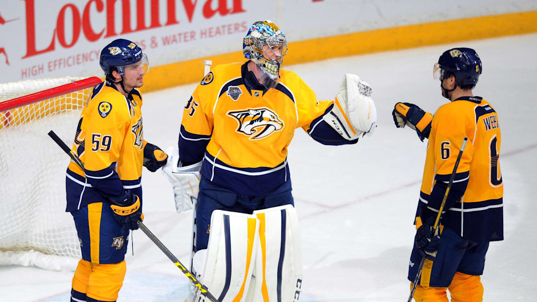 Feb 18, 2016; Nashville, TN, USA; Nashville Predators goalie Pekka Rinne (35) celebrates with defenseman Roman Josi (59) and Shea Weber (6) after a win against the Boston Bruins at Bridgestone Arena. The Predators won 2-0. Mandatory Credit: Christopher Hanewinckel-Imagn Images