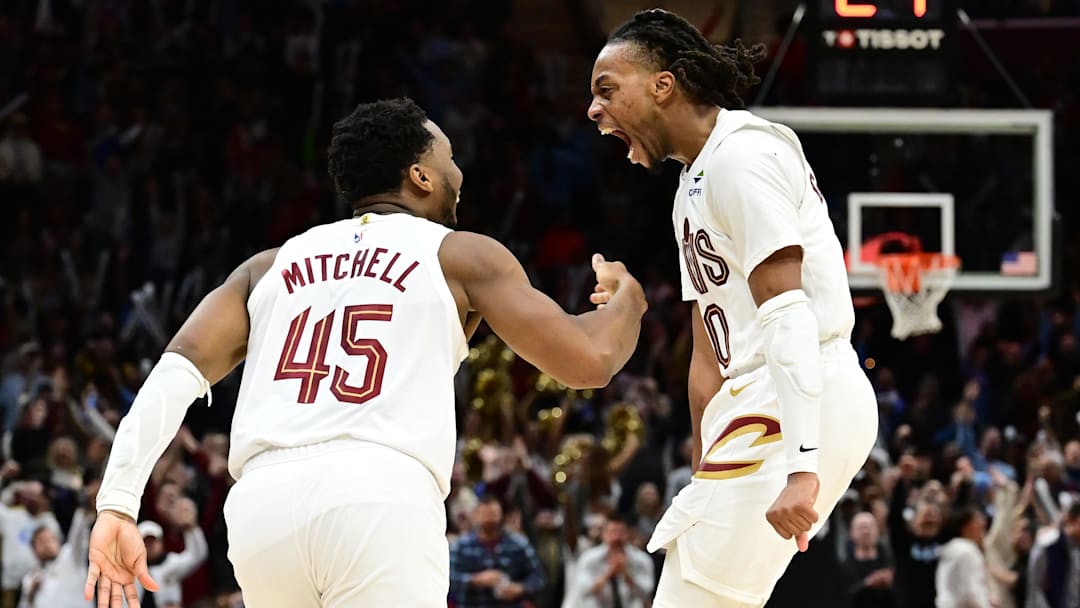 Jan 8, 2025; Cleveland, Ohio, USA; Cleveland Cavaliers guard Donovan Mitchell (45) and guard Darius Garland (10) celebrate after Mitchell made a three point basket during the second half against the Oklahoma City Thunder at Rocket Mortgage FieldHouse. Mandatory Credit: Ken Blaze-Imagn Images