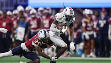 Dec 14, 2024; Atlanta, GA, USA; Jackson State Tigers wide receiver Isaiah Spencer (11) is tackled by South Carolina State Bulldogs defensive back Kwantre Harry (24) in the third quarter at Mercedes-Benz Stadium. Mandatory Credit: Brett Davis-Imagn Images
