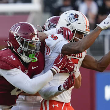 Nov 16, 2024; Tuscaloosa, AL, USA; Alabama Crimson Tide linebacker Deontae Lawson (0) and defensive back DeVonta Smith (8) break up a pass intended for Mercer Bears wide receiver Javarius George (5) at Bryant-Denny Stadium. Mandatory Credit: Gary Cosby Jr.-Imagn Images