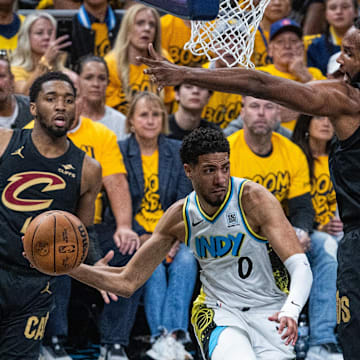 Indiana Pacers guard Tyrese Haliburton attempts to pass around Cleveland Cavaliers' Evan Mobley.