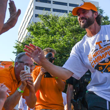 Tennessee head baseball coach Tony Vitello high-fives fans during the NCAA Baseball National Championship celebration in Downtown Knoxville on Tuesday, June 25, 2024.