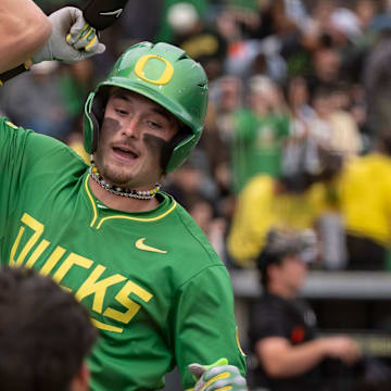 Oregon outfielder Mason Neville, right, celebrates a home run with teammate Drew Smith as the Oregon Ducks host the Oregon State Beavers on April 25, 2025, at PK Park in Eugene.