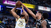 Nov 5, 2025; Indianapolis, Indiana, USA; Indiana Pacers forward Jeremiah Robinson-Earl (25) shoots the ball while Brooklyn Nets forward Michael Porter Jr. (17) defends in the first half  at Gainbridge Fieldhouse. Mandatory Credit: Trevor Ruszkowski-Imagn Images