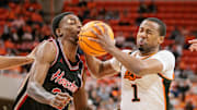 Dec 30, 2024; Stillwater, Oklahoma, USA; Oklahoma State Cowboys guard Bryce Thompson (1) collides with Houston Cougars guard Terrance Arceneaux (23) during the first half at Gallagher-Iba Arena. Mandatory Credit: William Purnell-Imagn Images