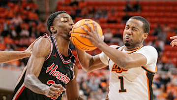 Dec 30, 2024; Stillwater, Oklahoma, USA; Oklahoma State Cowboys guard Bryce Thompson (1) collides with Houston Cougars guard Terrance Arceneaux (23) during the first half at Gallagher-Iba Arena. Mandatory Credit: William Purnell-Imagn Images