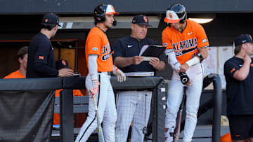 Oklahoma State coach Josh Holiday talks with Brayden Smith, right, and Drew Culbertson during a college Bedlam baseball game between the University of Oklahoma Sooners (OU) and the Oklahoma State University Cowboys (OSU) at O'Brate Stadium in Stillwater, Okla., Tuesday, April 15, 2025.
