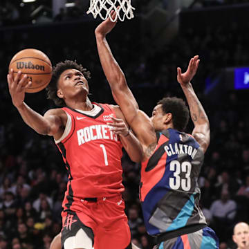 Jan 27, 2024; Brooklyn, New York, USA;  Houston Rockets forward Amen Thompson (1) looks to drive past Brooklyn Nets center Nic Claxton (33) in the fourth quarter at Barclays Center. Mandatory Credit: Wendell Cruz-Imagn Images