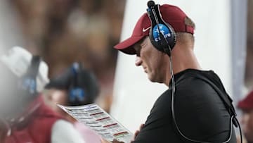 Oct 18, 2025; Tuscaloosa, Alabama, USA;  Alabama head coach Kalen DeBoer studies his play sheet during the second quarter against the Tennessee Volunteers at Saban Field at Bryant-Denny Stadium. Mandatory Credit: Gary Cosby-USA TODAY Network via Imagn Images