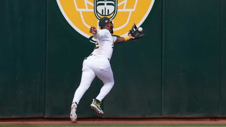 Aug 17, 2024; Oakland, California, USA; Oakland Athletics left fielder Miguel Andujar (22) catches a fly ball against the San Francisco Giants during the first inning at Oakland-Alameda County Coliseum. Mandatory Credit: Darren Yamashita-USA TODAY Sports