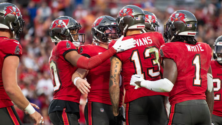 Dec 24, 2023; Tampa, Florida, USA; Tampa Bay Buccaneers quarterback Baker Mayfield (6) and wide receiver Mike Evans (13) celebrate a touchdown against the Jacksonville Jaguars in the second quarter at Raymond James Stadium. Mandatory Credit: Jeremy Reper-USA TODAY Sports