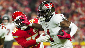 Nov 4, 2024; Kansas City, Missouri, USA; Tampa Bay Buccaneers running back Rachaad White (1) runs the ball against Kansas City Chiefs linebacker Joshua Uche (55) during the first half at GEHA Field at Arrowhead Stadium. Mandatory Credit: Jay Biggerstaff-Imagn Images