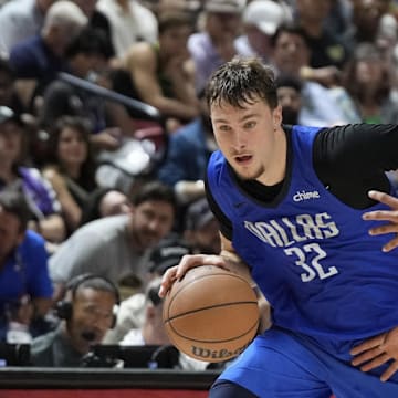 Dallas Mavericks forward Cooper Flagg drives past San Antonio Spurs forward Carter Bryant.