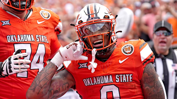 Oklahoma State's Ollie Gordon II celebrates his touchdown with Preston Wilson in opening win.