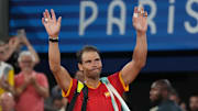 Rafael Nadal waves to the Paris Olympic crowd.