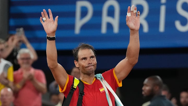 Rafael Nadal waves to the Paris Olympic crowd.