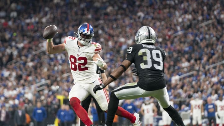 November 5, 2023; Paradise, Nevada, USA; New York Giants tight end Daniel Bellinger (82) runs the football against Las Vegas Raiders cornerback Nate Hobbs (39) during the fourth quarter at Allegiant Stadium.  