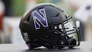 Nov 11, 2023; Madison, Wisconsin, USA;  General view of a Northwestern Wildcats helmet on the sidelines during the game against the Wisconsin Badgers at Camp Randall Stadium. Mandatory Credit: Jeff Hanisch-Imagn Images