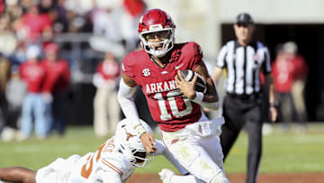 Nov 16, 2024; Fayetteville, Arkansas, USA; Arkansas Razorbacks quarterback Taylen Green (10) rushes in the third quarter as Texas Longhorns defensive back Jelani McDonald (25) defends at Donald W. Reynolds Razorback Stadium. Texas won 20-10. Mandatory Credit: Nelson Chenault-Imagn Images