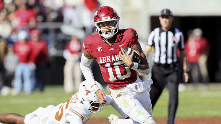Nov 16, 2024; Fayetteville, Arkansas, USA; Arkansas Razorbacks quarterback Taylen Green (10) rushes in the third quarter as Texas Longhorns defensive back Jelani McDonald (25) defends at Donald W. Reynolds Razorback Stadium. Texas won 20-10. Mandatory Credit: Nelson Chenault-Imagn Images