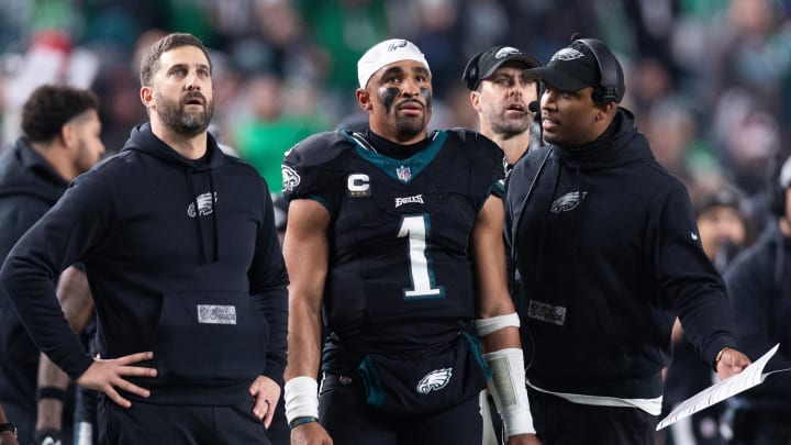 Dec 25, 2023; Philadelphia, Pennsylvania, USA; Philadelphia Eagles head coach Nick Sirianni (L) and quarterback Jalen Hurts (1) and offensive coordinator Brian Johnson (R) talk during the second quarter against the New York Giants at Lincoln Financial Field. Mandatory Credit: Bill Streicher-USA TODAY Sports