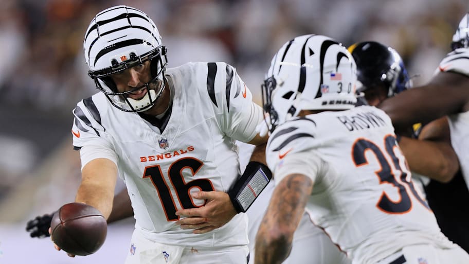 Bengals quarterback Joe Flacco (16) hands the ball off to running back Chase Brown (30) during a game against the Steelers.