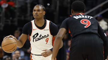 Detroit Pistons forward Ausar Thompson (9) dribbles defended by Toronto Raptors guard RJ Barrett (9) in the first half at Little Caesars Arena.