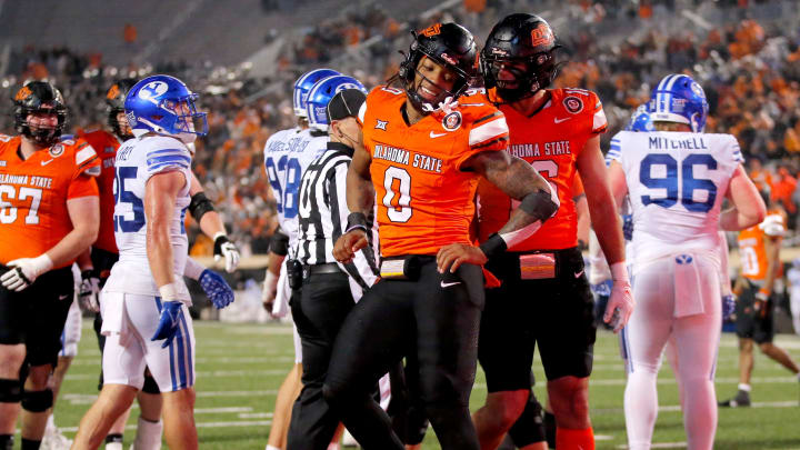 Oklahoma State's Ollie Gordon (0) reacts after a touchdown in the second half of the college football game between the Oklahoma State University Cowboys and the Brigham Young Cougars at Boone Pickens Stadium in Stillwater, Okla., Saturday, Nov. 25, 2023.