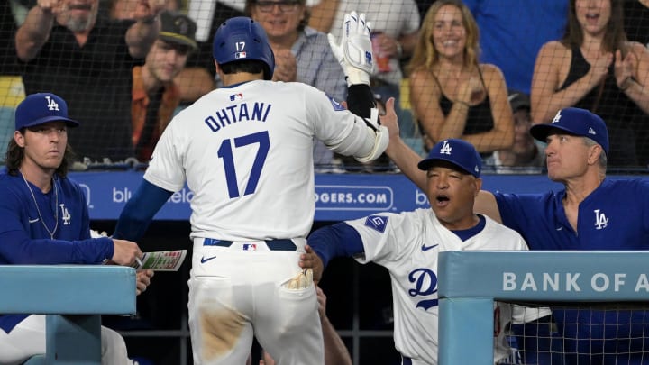 Aug 5, 2024; Los Angeles, California, USA;  Los Angeles Dodgers designated hitter Shohei Ohtani (17) is congratulated at the dugout by manager Dave Roberts (30) after hitting a solo home run in the eighth inning against the Philadelphia Phillies at Dodger Stadium.